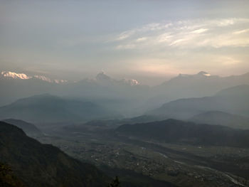 Scenic view of mountains against cloudy sky