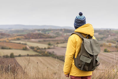 Rear view of man standing on field