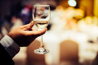 Close-up of hand holding wineglass