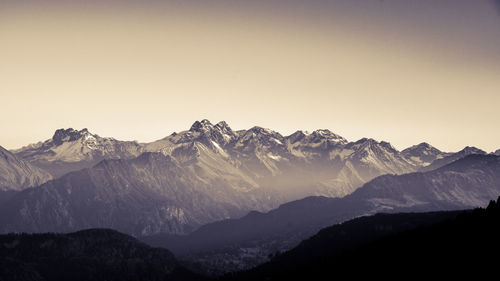 Scenic view of snowcapped mountains against clear sky