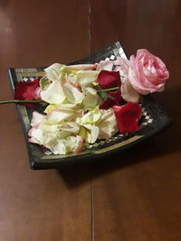 High angle view of roses in plate on table