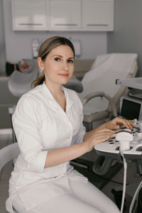 Portrait of young woman using laptop at home