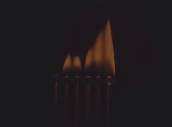 Close-up of lamp over black background