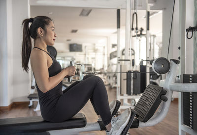 Side view of senior woman exercising in gym