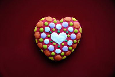 Close-up of heart shape over colored background