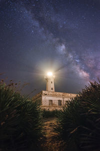 Illuminated building against sky at night
