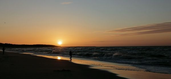 Scenic view of beach against sky during sunset