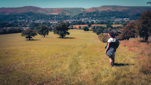 Girl with camera, tripod and microphone in a field