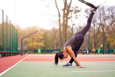 Woman exercising on sports court