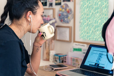 Side view of woman using mobile phone