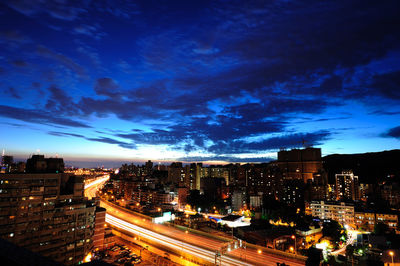 High angle view of illuminated buildings in city at night