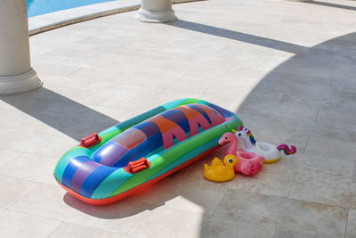 Inflatable mattress for swimming, stands for cocktails near pool on bright sunny day, copy space.