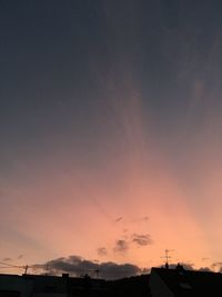 Silhouette roof against sky during sunset