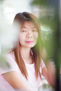 Portrait of mature woman sitting at backyard