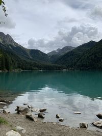 Scenic view of lake and mountains against sky