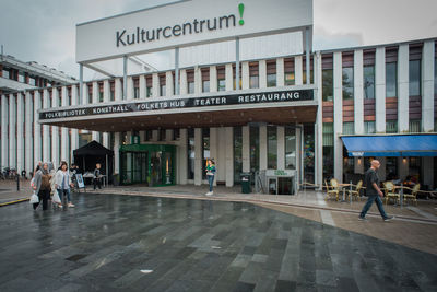 People walking in front of building