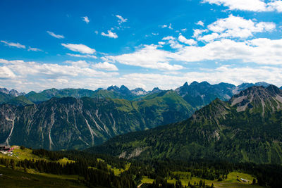 Scenic view of rocky mountains against cloudy sky