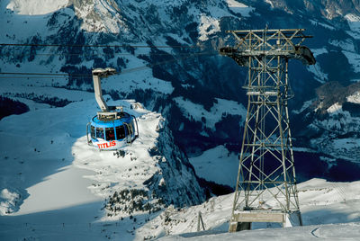 Ski lift over snowcapped mountains