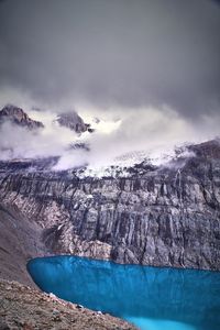 Aerial view of icebergs on snowcapped mountain against sky