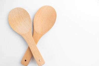 Directly above shot of wooden spoons on white background
