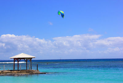 Lifeguard hut in sea against sky