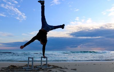 Full length of man at beach against sky