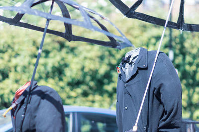 Rear view of person holding metal