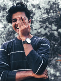 Portrait of young man standing in park