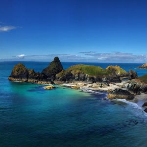 Scenic view of sea from lizard point against blue sky