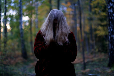 Woman standing in forest