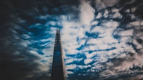 Low angle view of communications tower against sky