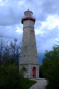 Low angle view of tower amidst buildings against sky