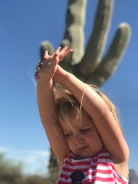 Midsection of boy standing against clear sky