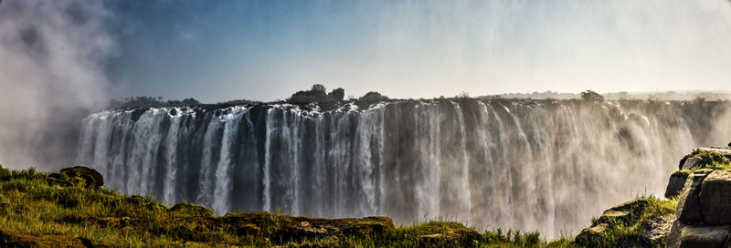 Panoramic view of waterfall against sky