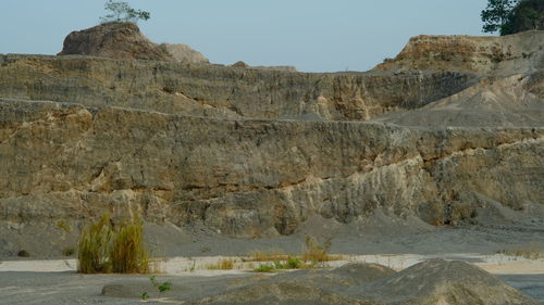 Rock formations on landscape against sky