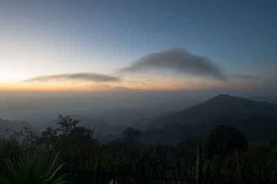 Scenic view of silhouette mountains against sky at sunset