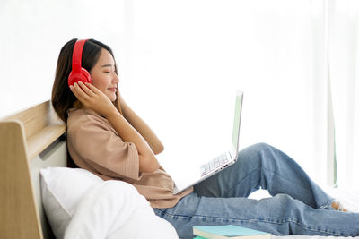 Woman sitting on sofa at home