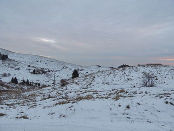 Scenic view of snow covered mountains against sky