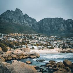 Scenic view of sea by buildings against sky