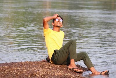 Side view of woman sitting in lake