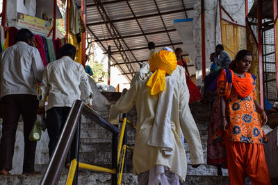 Rear view of people standing on temple