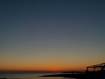 Scenic view of sea against clear sky during sunset