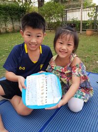 Portrait of smiling boy sitting outdoors