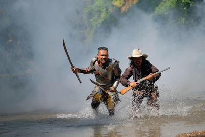 Full length of men on water