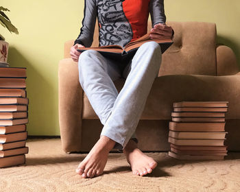 Low section of man sitting on sofa