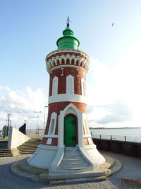 Low angle view of lighthouse against building