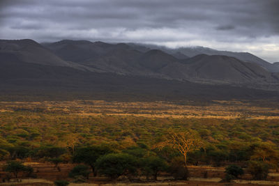 Scenic view of mountains against cloudy sky