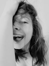 Close-up portrait of young woman against white background