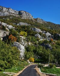 Road amidst rocks against sky