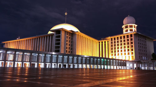 Illuminated building against sky at night